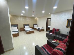 亚喀巴Zuwwar Aqaba的一间带两张床和一张沙发的客厅