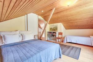 基尔科努米Villa Porkkala - Seafront Jacuzzi Nature Reserve的一间卧室设有两张床和木制天花板