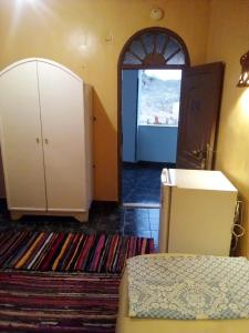 Mandīshahoasis panorama的一间设有一张床和一个衣柜及一扇门的房间