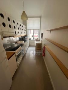 斯德哥尔摩Home Inn LNG20的厨房配有白色橱柜和长长的走廊