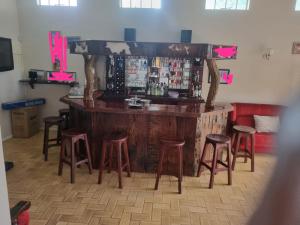 布拉瓦约The Villa的一个带凳子的酒吧,位于带柜台的房间