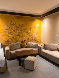 阿加迪尔La Suite Hotel-Adults friendly 16 Years plus的客厅配有沙发,墙上挂有绘画作品