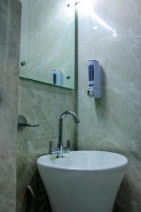 法里达巴德Agrah Stay - Kasa Lusso Stay的浴室设有白色水槽和镜子
