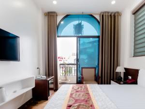 河内Phuong Nam Luxury Hotel Long Bien的一间卧室设有一张床和一个大窗户