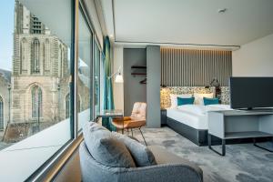 鹿特丹Motel One Rotterdam的一间酒店客房,配有一张床和一台电视