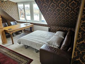 罗基什基斯Square apartments的一间卧室配有一张床、一张桌子和一张沙发