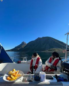 哈尔斯塔Weekend liveaboard sailing tour的船上有两名妇女,有一盘食物