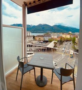 洛迦诺加尼蒙塔尔迪酒店的市景阳台配有桌椅