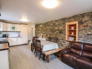 Curragh Cottage的厨房以及带桌子和沙发的客厅。