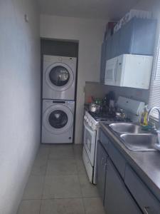 罗得城Impeccable Comfortable 1-Bed Apartment的厨房配有洗衣机和洗衣机。