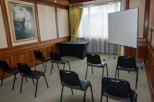 蒙特港abba Presidente Suites Puerto Montt的一间会议室,配有椅子和白色屏幕