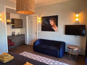 斯内克斯内克城市酒店的客厅配有蓝色的沙发和墙上的绘画