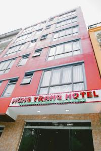 三岛县Khách Sạn Hùng Trang Hotel的一座红色的建筑,上面有读取获奖旅游酒店的标志