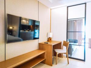 努沙杜瓦Pearl Nusa Dua Suite的墙上设有大屏幕平面电视的房间