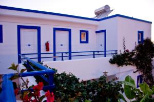 蒂加基蒂加基之星酒店的白色的建筑,有蓝色的门,有些花
