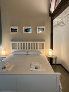 阿巴迪亚拉里亚纳Villa Onedo的卧室配有一张白色床,墙上挂有三张照片