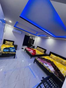 伊斯兰堡Moven Inn Hotel Islamabad的客房设有两张床和蓝色的天花板。