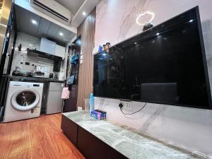 香港Sleep Cubee Hostel的厨房里的墙上有大屏幕平面电视