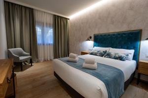 Zarza la MayorComplejo Valle Grande的一间卧室配有一张大床和蓝色床头板