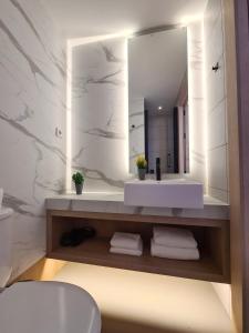巴塞罗那Hotel Casa Gardenia的浴室设有白色水槽和镜子
