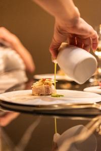 胡塔伦德巴里亚酒店的把食物倒在桌子上的盘子里的人