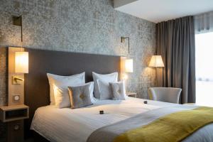 科尔马James Boutique Hôtel Colmar centre的酒店客房配有一张带白色枕头的大床