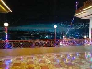 穆扎法拉巴德SEE MOTEL的享有城市美景,晚上配有圣诞灯