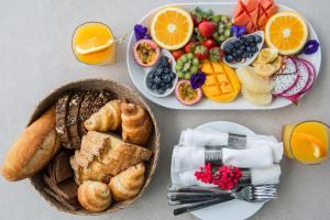 茶云莱海滩Villa Sasipimon - Panoramic Duplex Studio的一张桌子,上面放着两盘早餐食品和水果