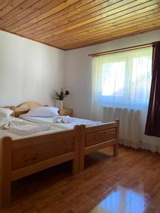 沃尔托普Casa de Vacanţă Vârtop的一间卧室设有一张大床和一个窗户。