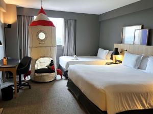 瓜鲁柳斯圣保罗瓜鲁柳斯机场铂尔曼酒店的酒店客房设有两张床和钟楼