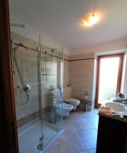 费拉迪普利米罗ROOM AURORA的一间带玻璃淋浴和卫生间的浴室