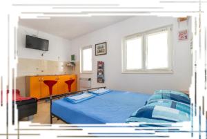 卡什泰拉奥卡塔林旅舍的一间卧室配有蓝色的床和电视
