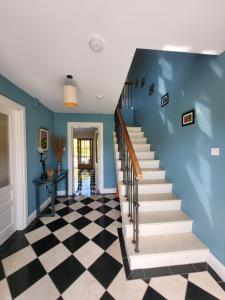 基拉尼Reeks Country House的一座带蓝色墙壁和 ⁇ 板的房屋内的楼梯