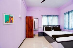 ĀsansolSPOT ON Hotel Sunshine Lodging的一间卧室设有两张床和紫色的墙壁