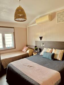 滨海阿热莱斯尼德酒店的一间卧室设有两张床和天花板