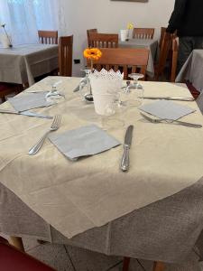 里米尼Due Gemelle的桌子上摆放着餐具和餐巾的桌子