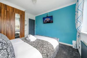 利兹*328OL* For your relaxed & Cosy stay + Parking的一间卧室设有一张床和蓝色的墙壁