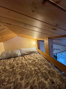 莫兰高地Chalet Alpin Suisse Au Bord Du Lac的一张位于带木制天花板的客房内的大床