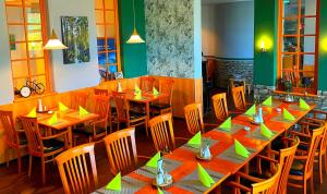 吕本瑙施普利瓦尔德贝斯特韦斯特酒店的用餐室配有长木桌子和椅子