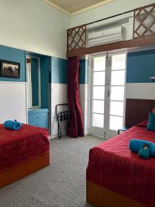 温顿北格雷戈里酒店的一间卧室设有两张床和窗户。