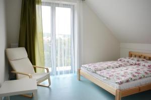 布尔诺梅姿斯托米旅馆 的卧室配有床、椅子和窗户。