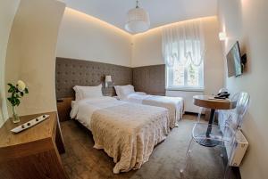 WilkówHotel Jakubus的酒店客房设有两张床和一张桌子。
