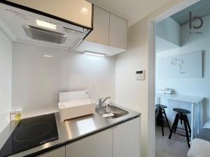 广岛bHOTEL Nekoyard - New Modern Beautiful 1 BR Apartment, Very Near Peace Park, for 6Ppl的厨房配有水槽和台面