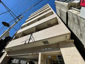 广岛bHOTEL Casaen - 1BR Apartment with beautiful City View Near Shopping District For 6Ppl的前面有标志的高楼