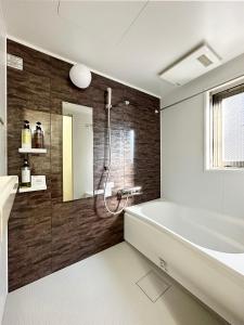 尾道市bHOTEL Yutori - Attractive 1Br Apt for 4 people in Onomichi的带浴缸和盥洗盆的浴室
