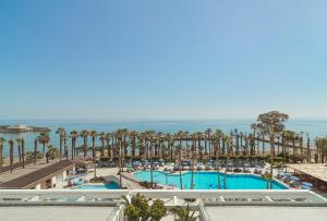 利马索尔The GrandResort - Limited Edition by Leonardo Hotels的享有带游泳池和棕榈树的度假村的空中景致