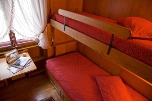 科尔蒂纳丹佩佐Casa Viola的小房间设有两张双层床和一张桌子