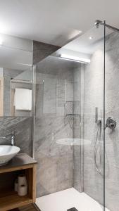普雷达佐Hotel La Montanara Predazzo的带淋浴和盥洗盆的浴室