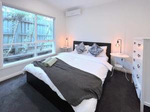 Mont AlbertLuxury Designer Home Villa Surrey Hills的一间卧室设有一张大床和一个窗户。