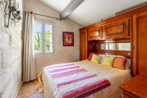 圣雷米普罗旺斯L'orangerie的一间卧室设有一张床和一个窗口